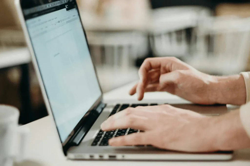 Detail of a professional editing text on a laptop.