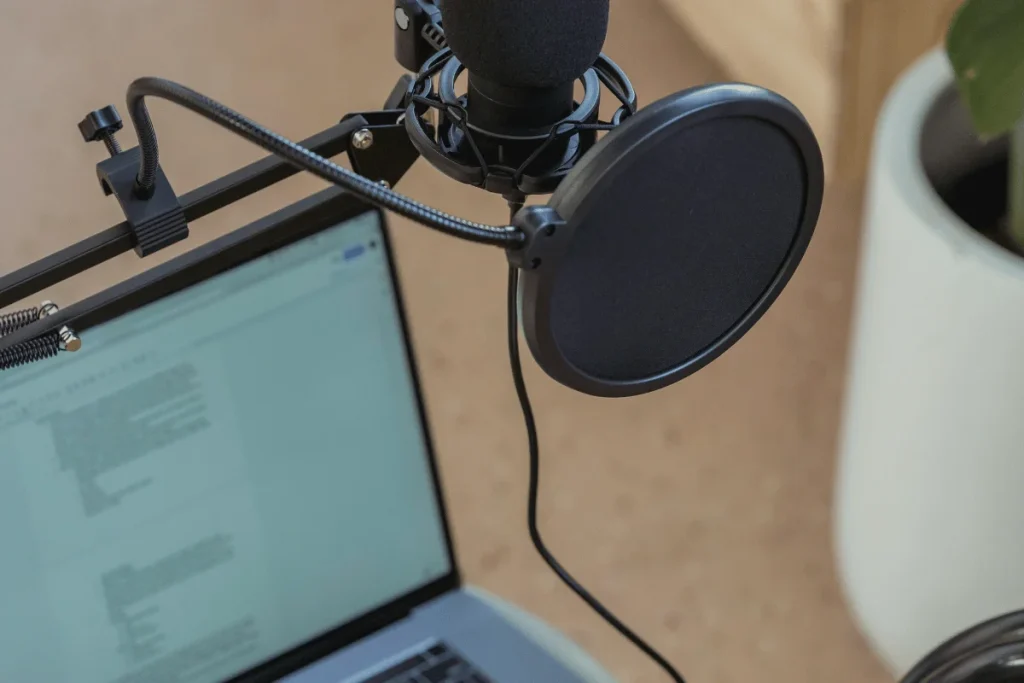 Microphone with pop filter in a podcast recording environment.