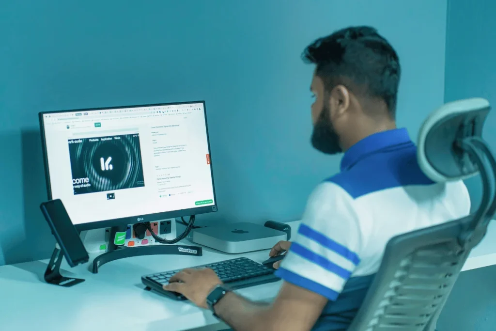 Professional viewing a website on an LG monitor in a contemporary workspace.