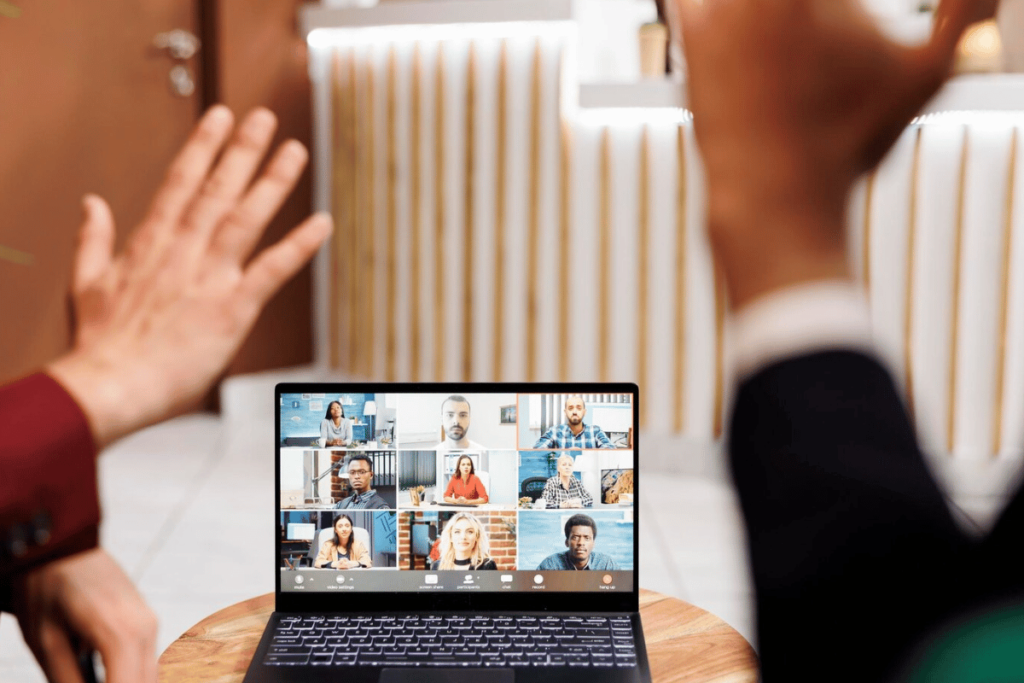 A video call setup with a person on the laptop screen.