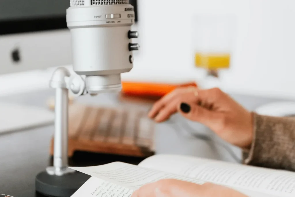 Close-up of a podcaster reading while recording audio.