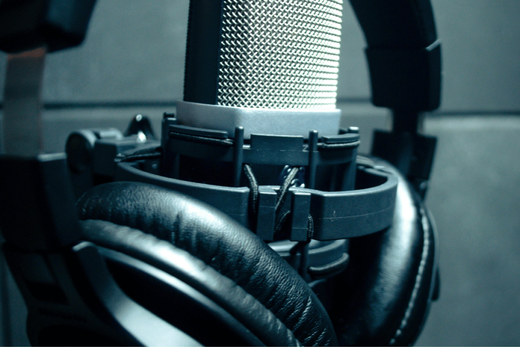 Close-up of professional microphone with black headphones in studio.