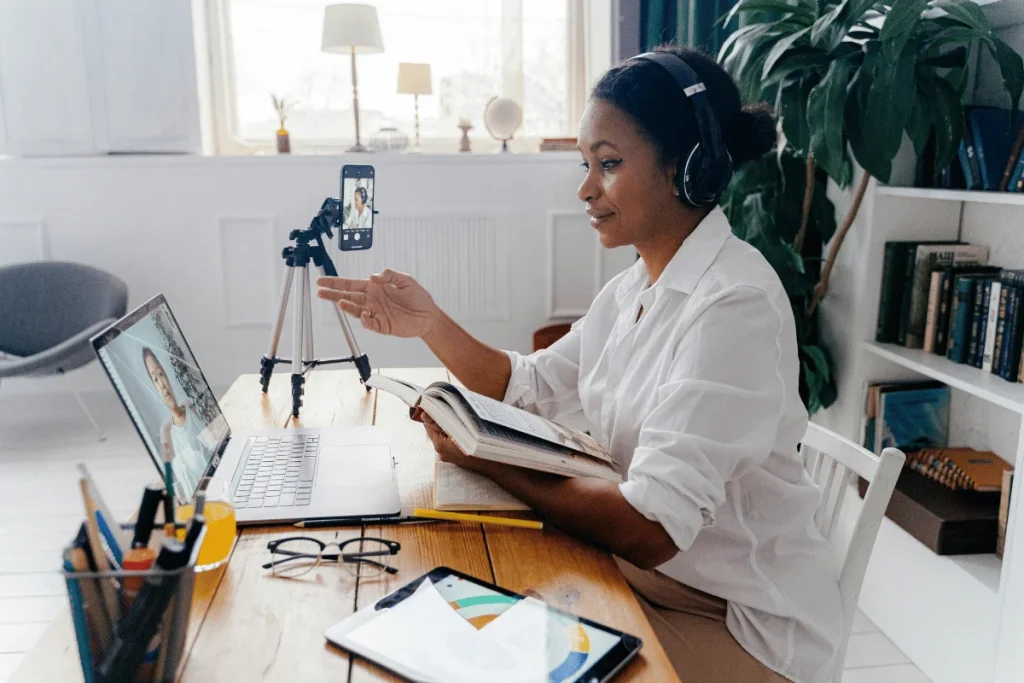 Professional woman hosting a virtual meeting at home with headphones on.