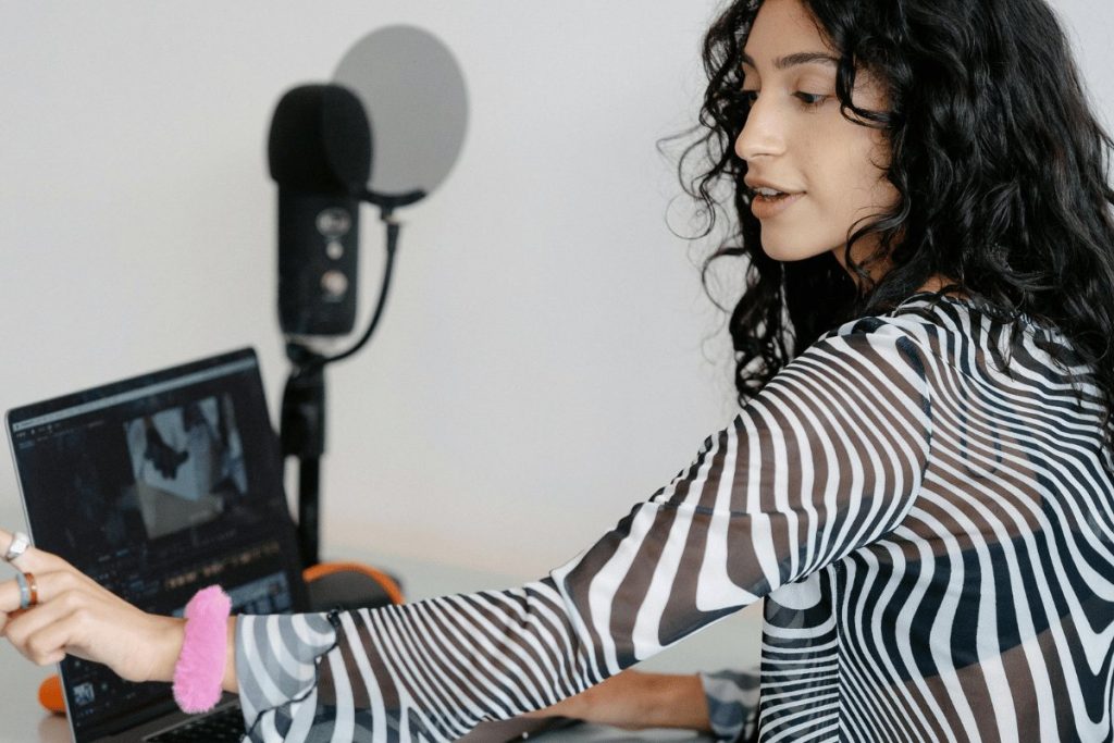 Female content creator working with audio and video setup.