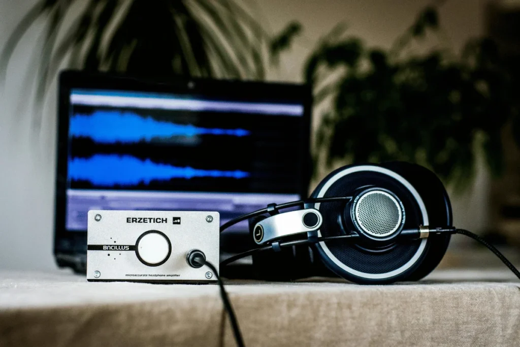 High-end audiophile headphones connected to a micro-accurate amplifier with blurred background.