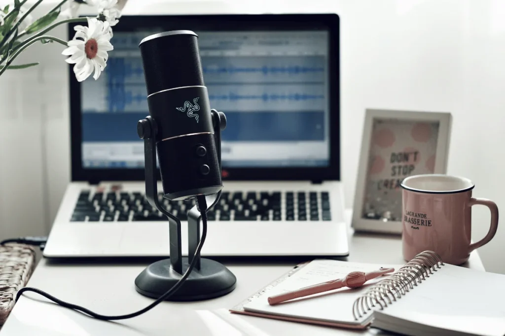 Podcasting setup with mic and laptop.