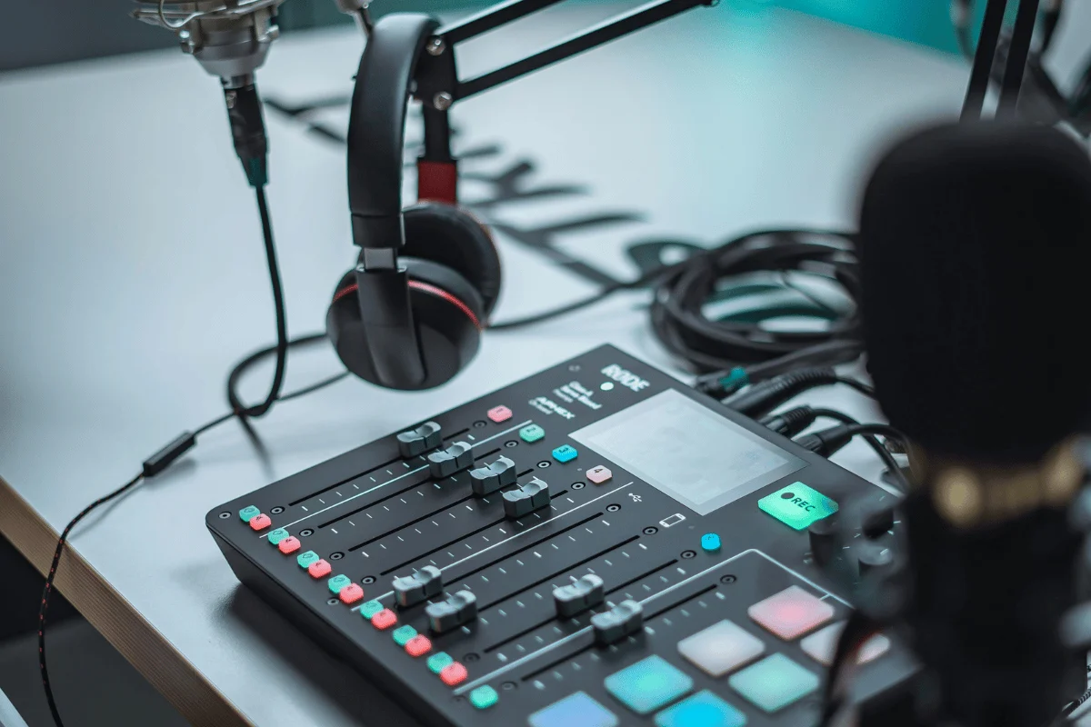 Professional podcast setup with a Rode audio mixer, microphone, and headphones.