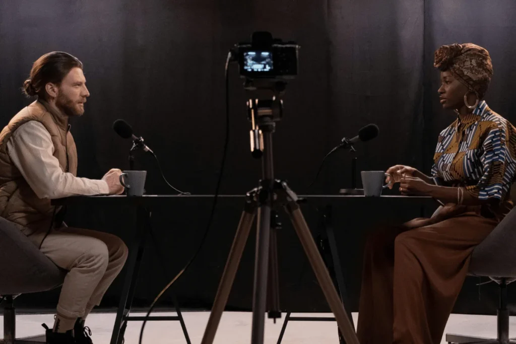 Interview setting with two people talking at a table.