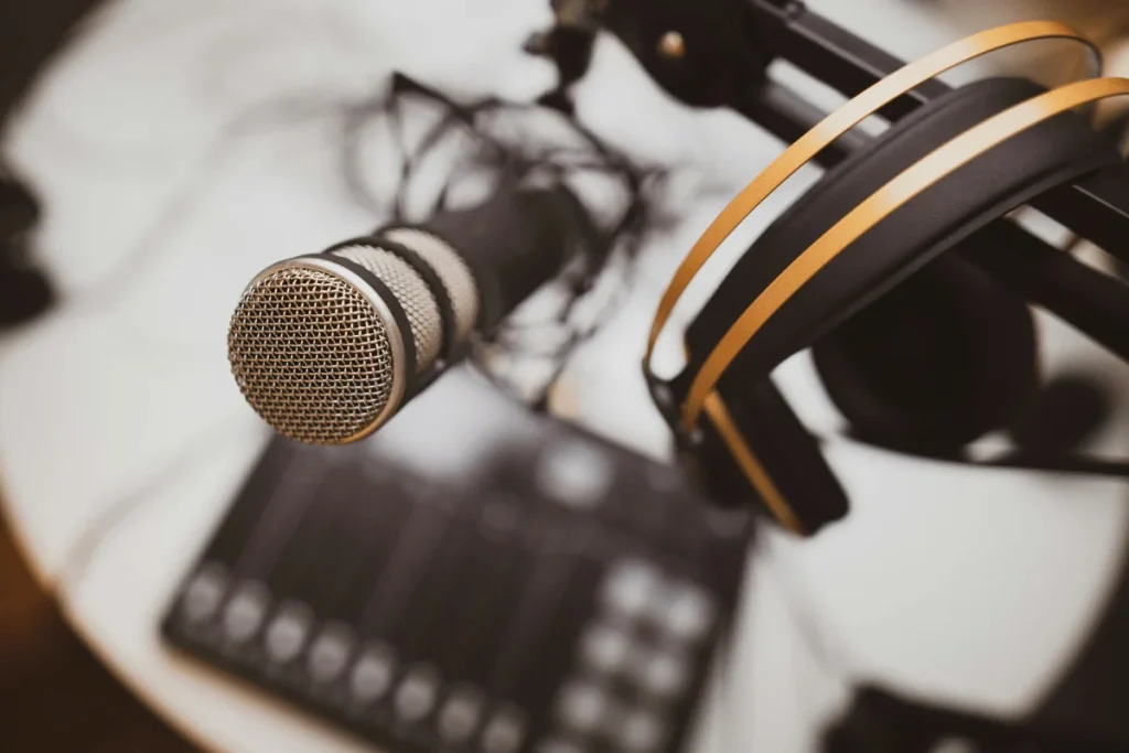 Professional podcast microphone and headphones setup in a studio.