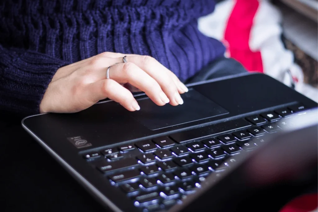 A person's hands typing on a keyboard, a symbol of modern work.