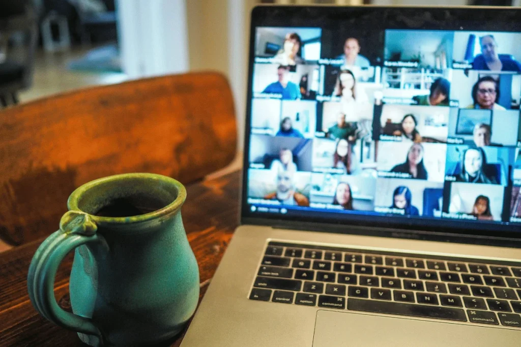 A laptop screen displaying a virtual team meeting with multiple participants.