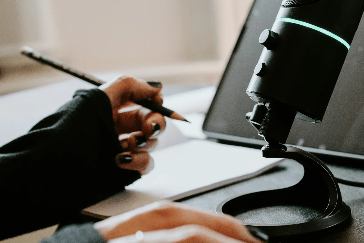 Podcasting microphone near a digital tablet.