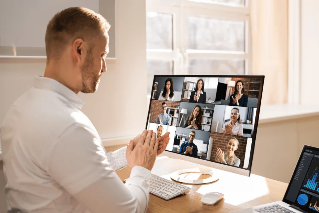 Person in a virtual meeting with multiple participants on a computer screen.