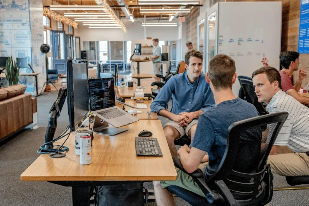 Team members discussing a project in a modern office environment.