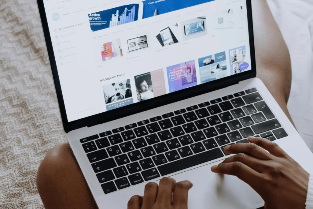 Person browsing a graphic design platform on a laptop.
