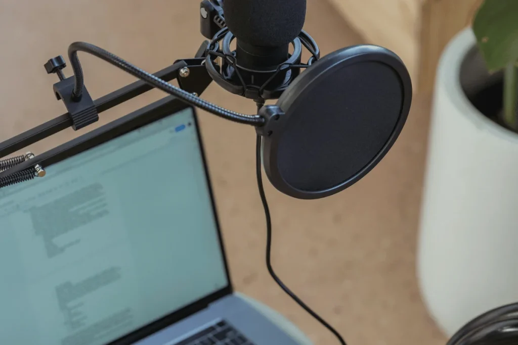 High-quality microphone with shock mount and pop filter for audio recording.