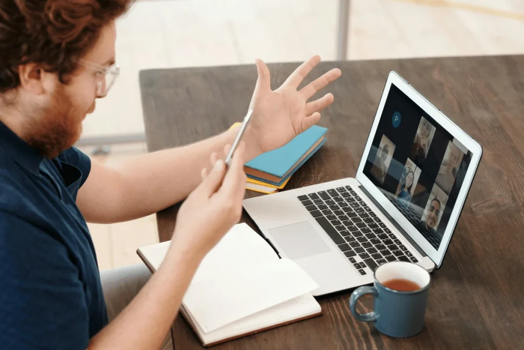 Man participating in a video conference call on a laptop.