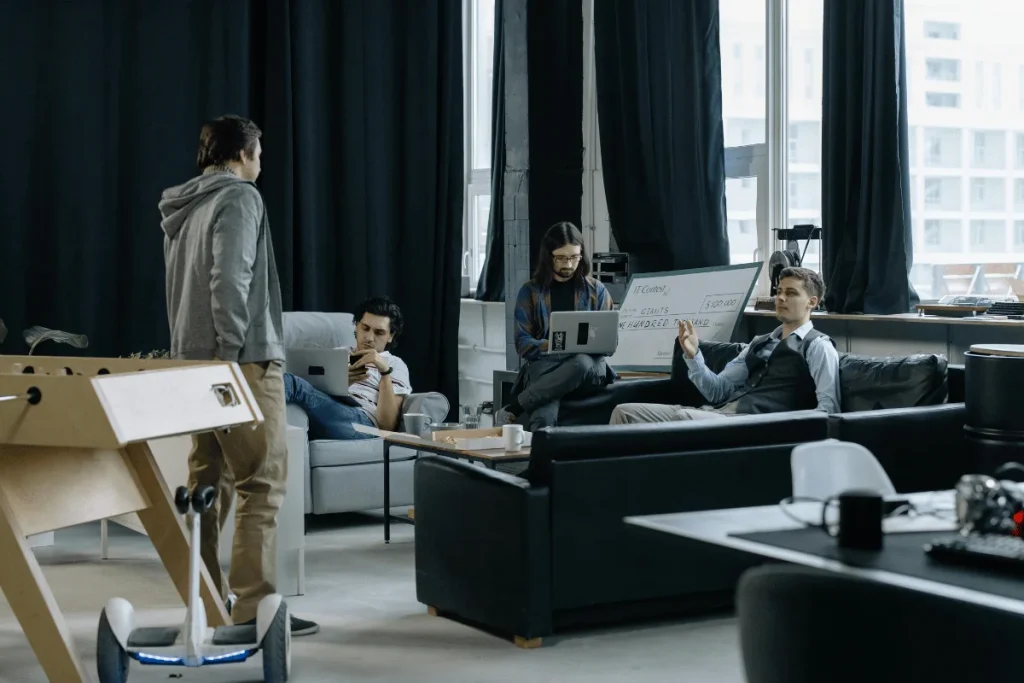 Team members working together and discussing ideas in a collaborative workspace.