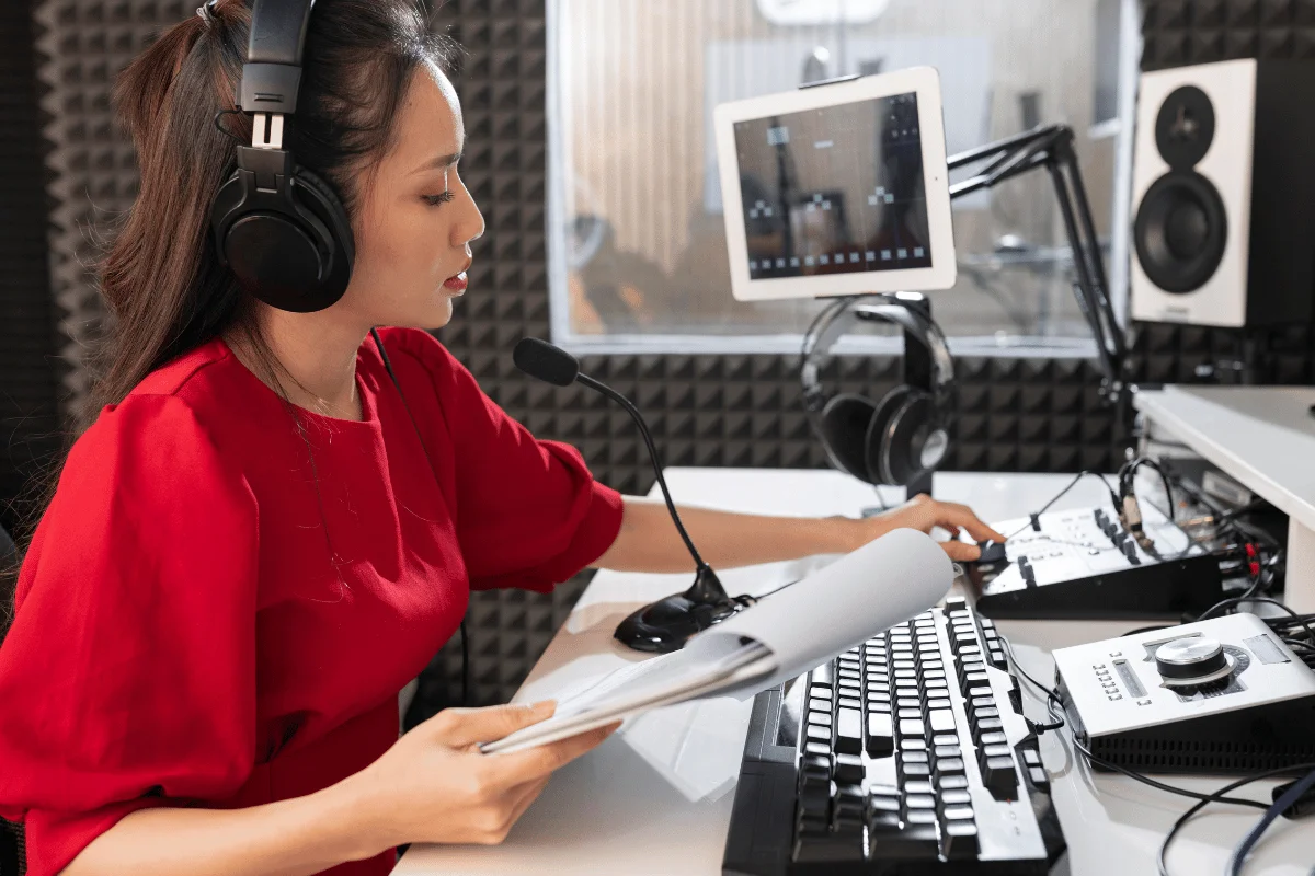 Broadcasting setup with mic, headset, and tablet.