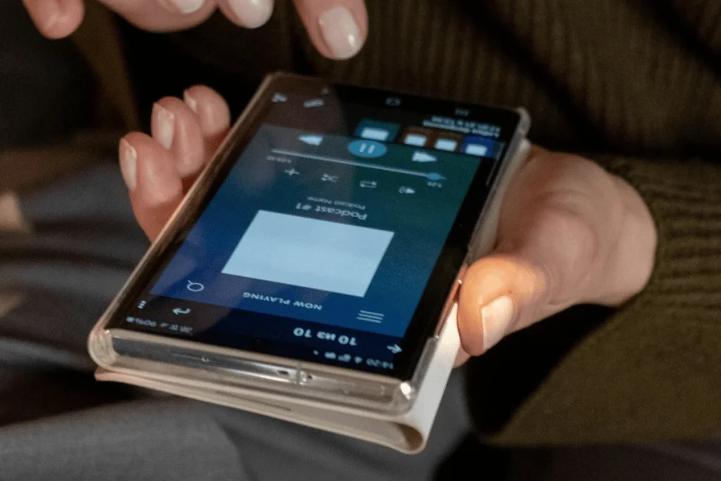 Person listening to Podcast #1 on a mobile device.