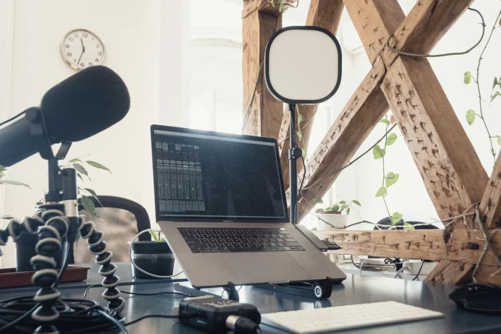 Home studio desk with microphone and MacBook.