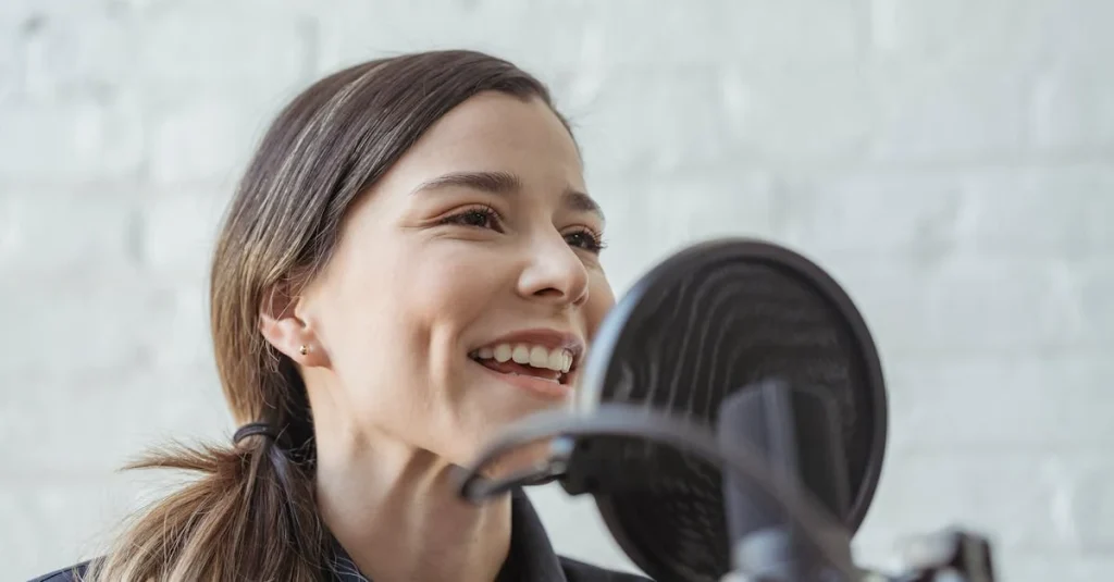 Woman smiling at microphone during remote podcast recording session with professional studio setup.