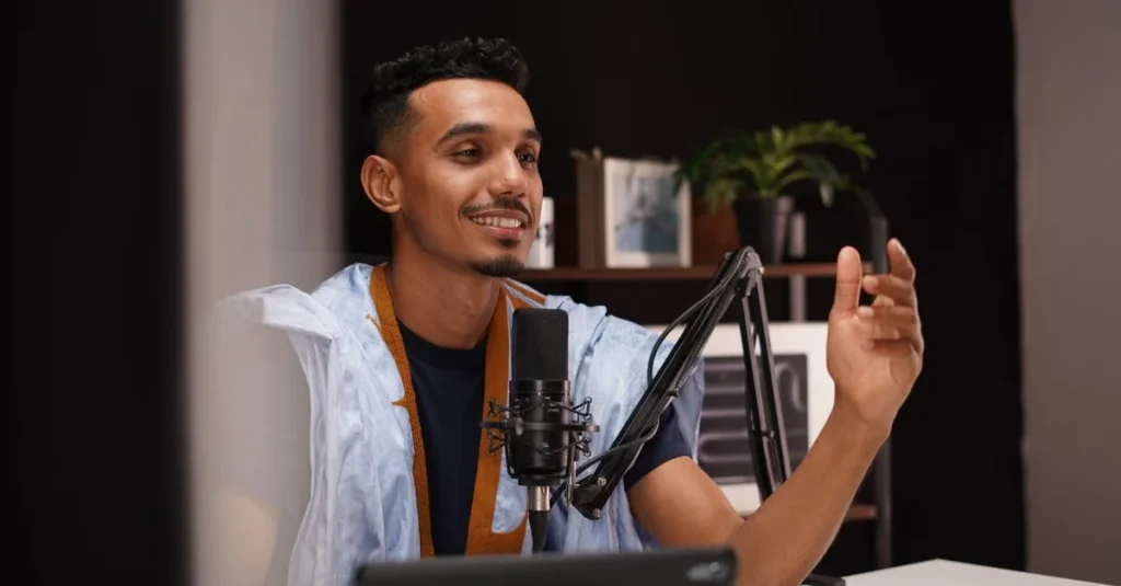 Male podcaster speaking into microphone at desk, exploring Supercast alternatives for audio content creation.