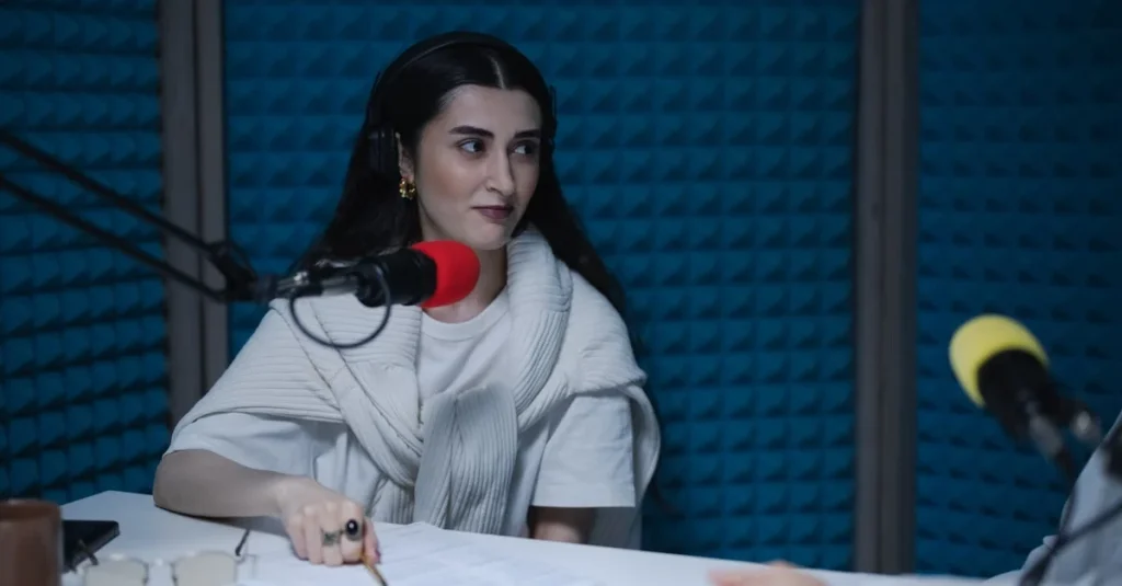 Woman speaking into red microphone in professional podcast studio discussing Supercast alternatives with co-host.
